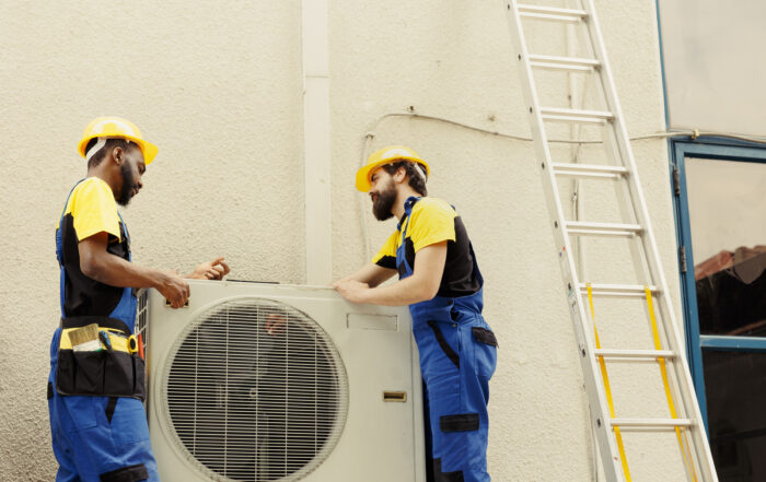 repairmen-taking-apart-hvac-system